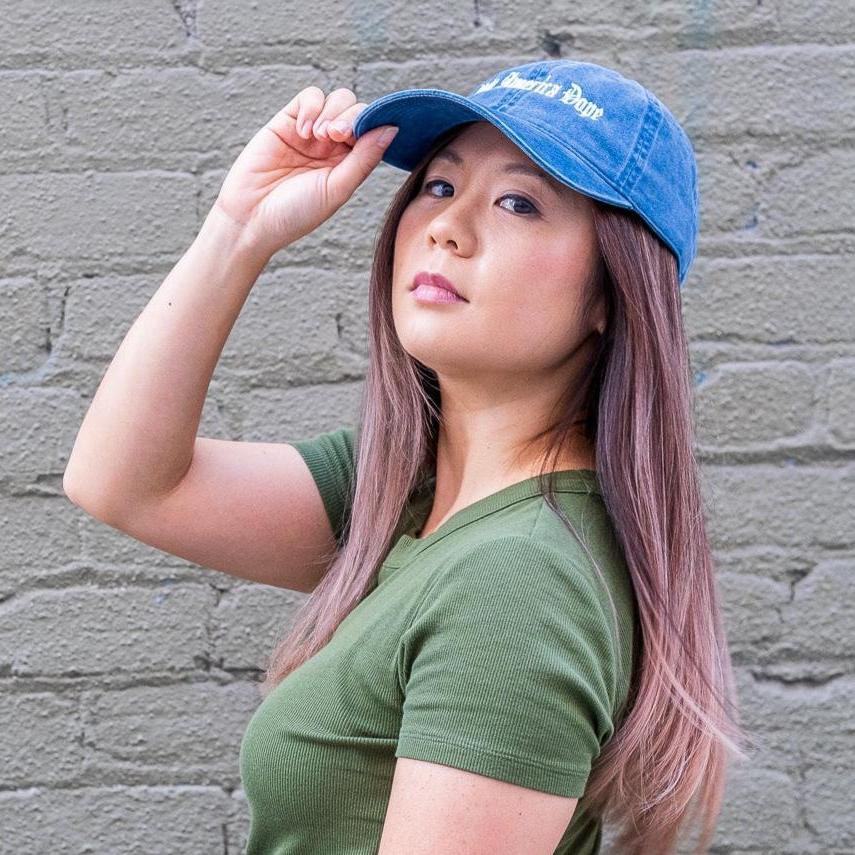 Woman wearing make america dope hat in front of wall
