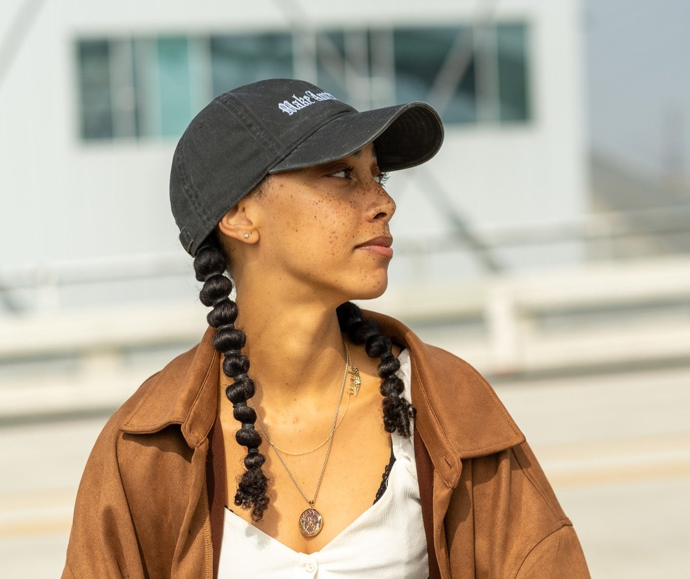 woman wearing make america dope hat on bridge