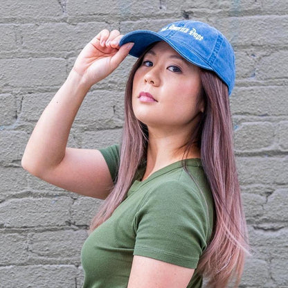 Woman wearing make america dope hat in front of wall